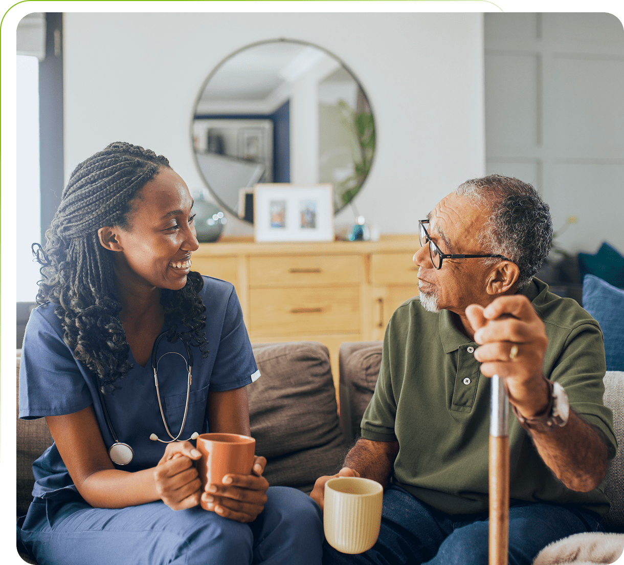 Nurse and elderly man enjoying conversation together.